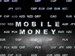 Image showing Currency concept: Mobile Money in grunge dark room