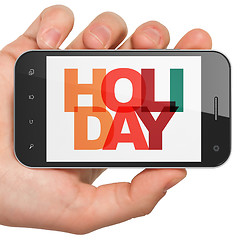 Image showing Entertainment, concept: Hand Holding Smartphone with Holiday on  display