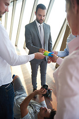 Image showing business people group assembling jigsaw puzzle