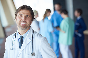 Image showing group of medical staff at hospital, handsome doctor in front of 