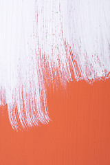 Image showing Orange board being roughly painted with white paint