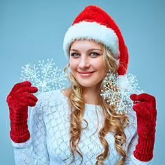 Image showing Beautiful young woman in Santa Claus clothes with snowflakes