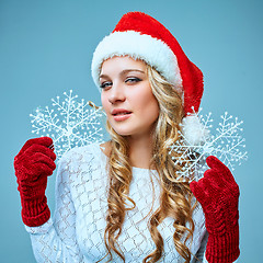 Image showing Beautiful young woman in Santa Claus clothes with snowflakes