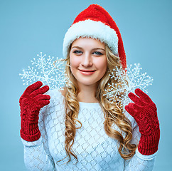 Image showing Beautiful young woman in Santa Claus clothes with snowflakes