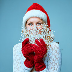 Image showing Beautiful young woman in Santa Claus clothes with snowflakes