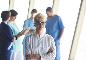 Image showing female doctor with glasses and blonde hairstyle standing in fron