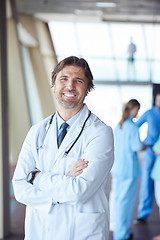 Image showing group of medical staff at hospital, handsome doctor in front of 