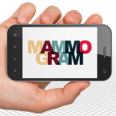 Image showing Healthcare concept: Hand Holding Smartphone with Mammogram on  display