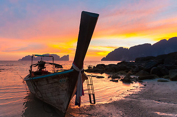 Image showing Traditional wooden longtail boat on beach in sunset, Thailand.