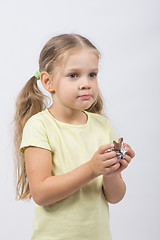 Image showing Portrait of a four-year girl with chocolate in hand