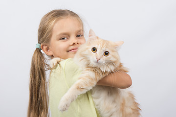 Image showing Six year old girl with a cat in her arms