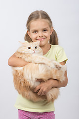 Image showing Six year old girl holding adult domestic cat