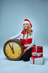 Image showing Girl dressed in santa hat with a Christmas decorations  