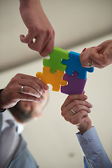 Image showing business people group assembling jigsaw puzzle