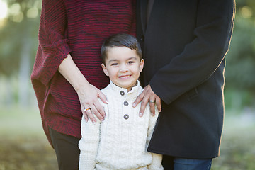 Image showing Young Mixed Race Boy Portrait Outdoors With Parents Behind