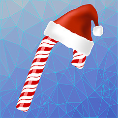 Image showing Sweet Red Candy Cane and Hat of Santa Claus