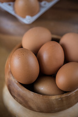 Image showing Fresh eggs at wooden plate 