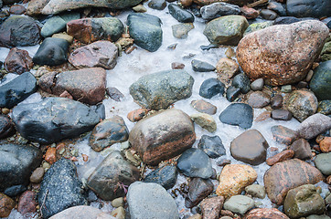 Image showing The freezed stones on coast of Baltic sea. A winter landscape