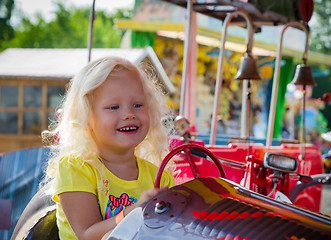 Image showing The child goes for a drive on a children\'s attraction