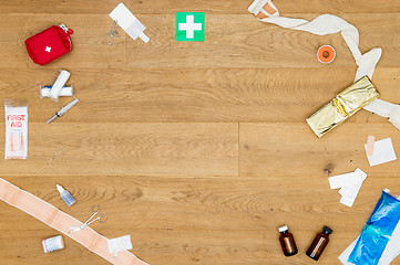Image showing Array of first aid kit objects on wooden surface with copyspace