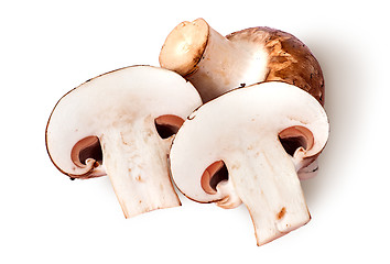 Image showing Whole and two half brown champignons