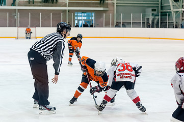 Image showing Puck playing between players of ice-hockey teams