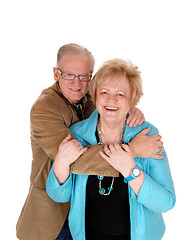Image showing Older couple hugging .