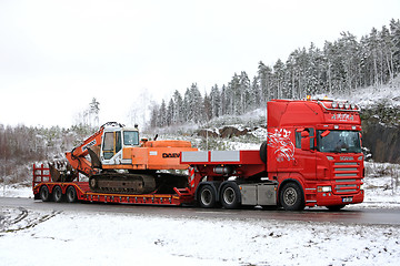 Image showing Red Scania R500 Hauls Daewoo Excavator on Winter Road