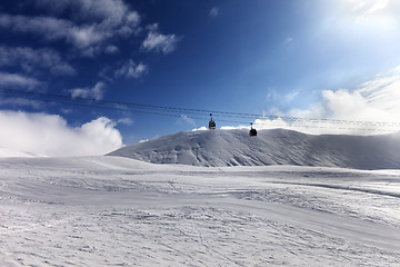 Image showing Gondola lift and ski slope at sun day