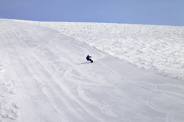 Image showing Ski slope and snowboarder at sun day