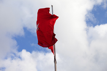 Image showing Turkish flag on flagpole waving in wind