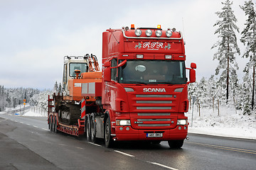 Image showing Red Scania R500 Hauls Daewoo Excavator on Winter Road