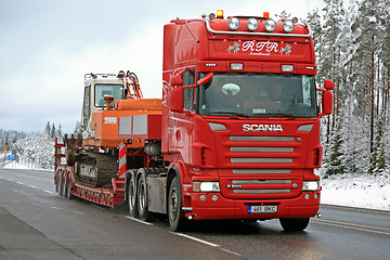 Image showing Red Scania R500 Hauls Daewoo Excavator on Winter Road