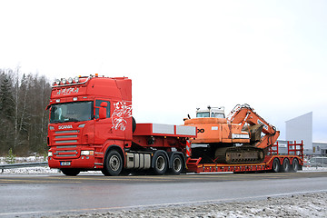 Image showing Red Scania R500 Hauls Daewoo Excavator on Winter Road