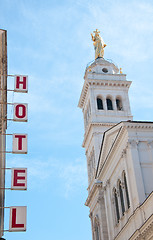 Image showing 
Sign written hotels silhouetted against the sky