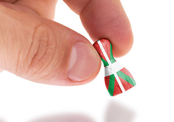 Image showing Hand holding wooden pawn, flag painting, selective focus