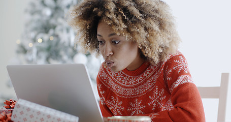 Image showing Excited woman shopping online for Xmas bargains