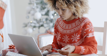 Image showing Young woman doing Xmas shopping online