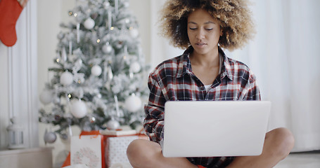 Image showing Young African student working on her laptop