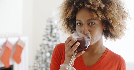 Image showing Young woman offering a Christmas toast