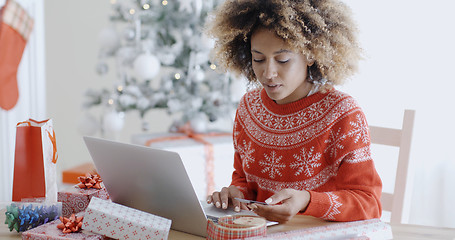 Image showing Young woman doing Xmas shopping online