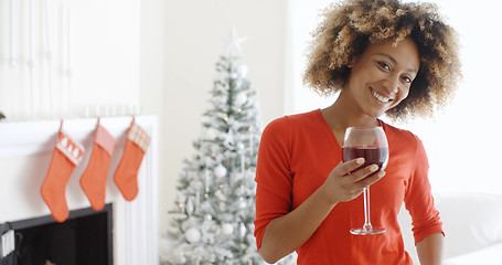 Image showing Young woman offering a Christmas toast