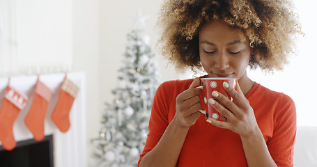 Image showing Pretty young African woman enjoying coffee