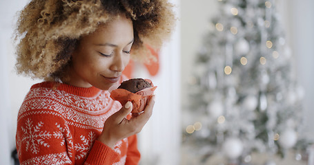 Image showing Young woman savoring a Christmas cake