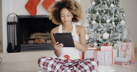 Image showing Young woman attending to Xmas social media