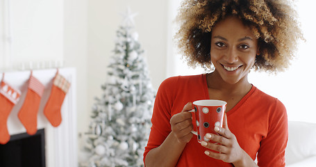 Image showing Pretty young African woman enjoying coffee