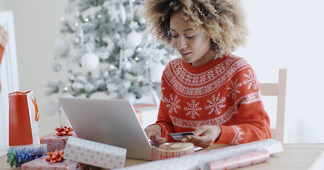 Image showing Young woman doing Xmas shopping online