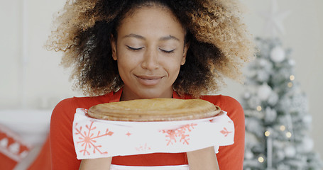 Image showing Young woman with a fresh Christmas tart