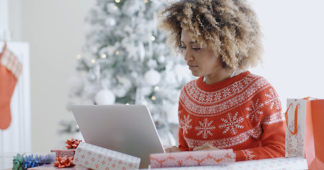 Image showing Trendy young woman working on a laptop