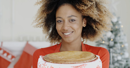 Image showing Young woman with a fresh Christmas tart